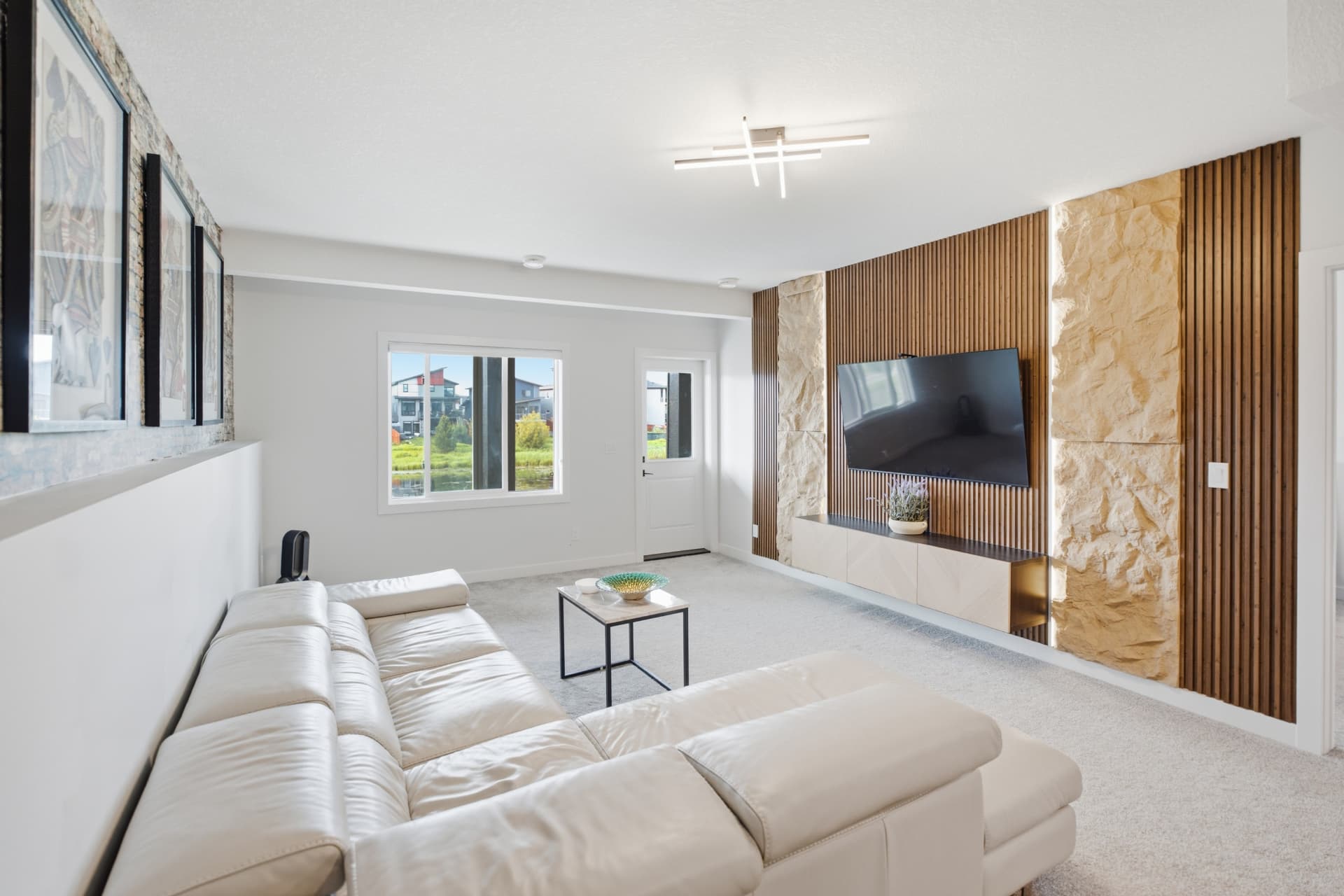 Lower-level family room with stone and wood feature wall