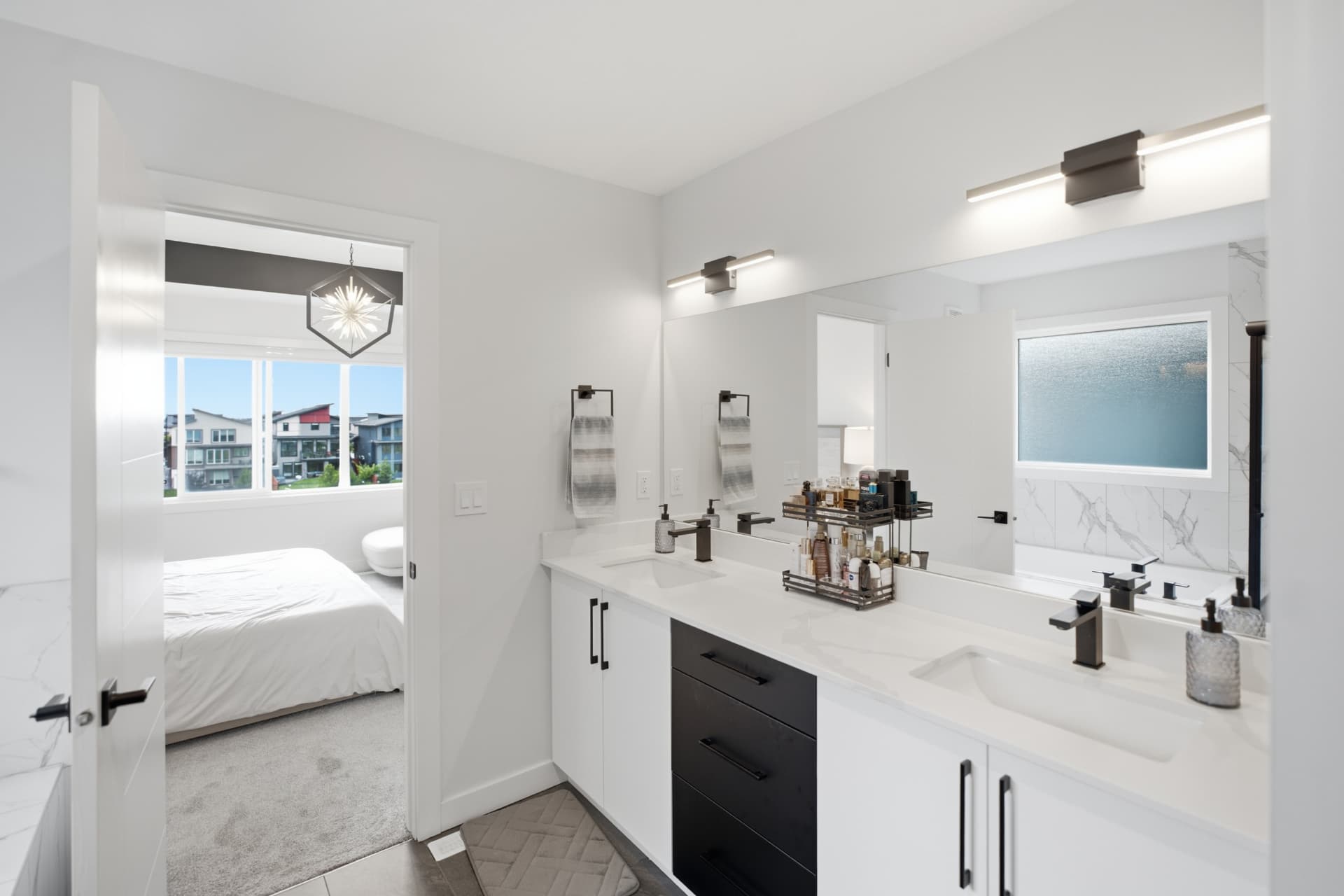 Ensuite bathroom with double vanity and large mirror