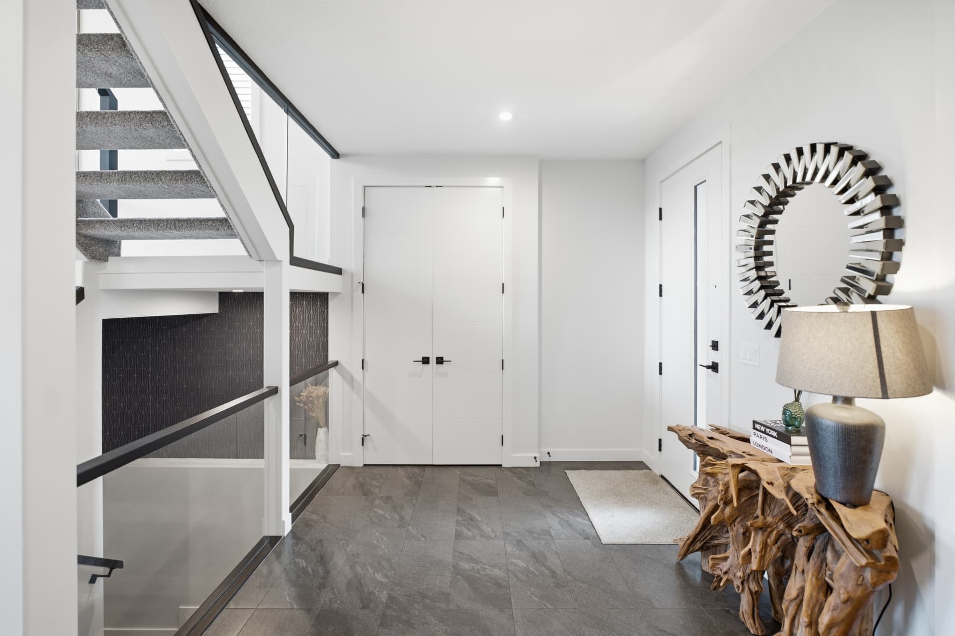 Bright entryway with staircase and tile flooring