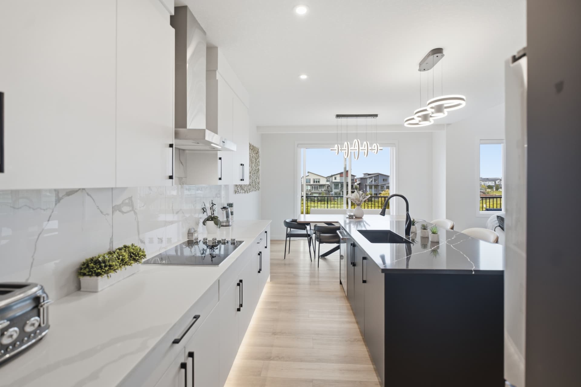 White kitchen with quartz island and dining area
