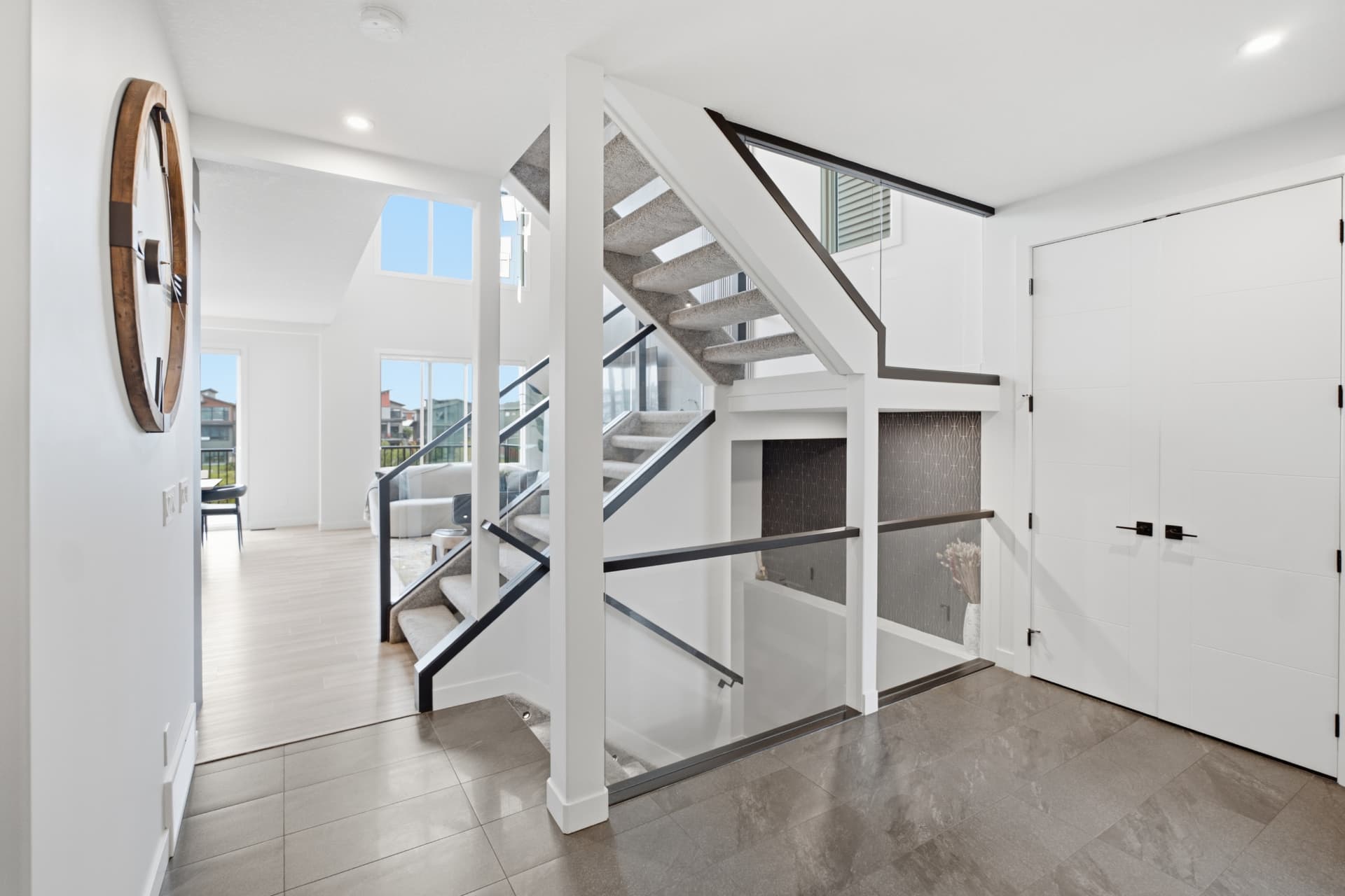 Open foyer with open-riser staircase and glass railing