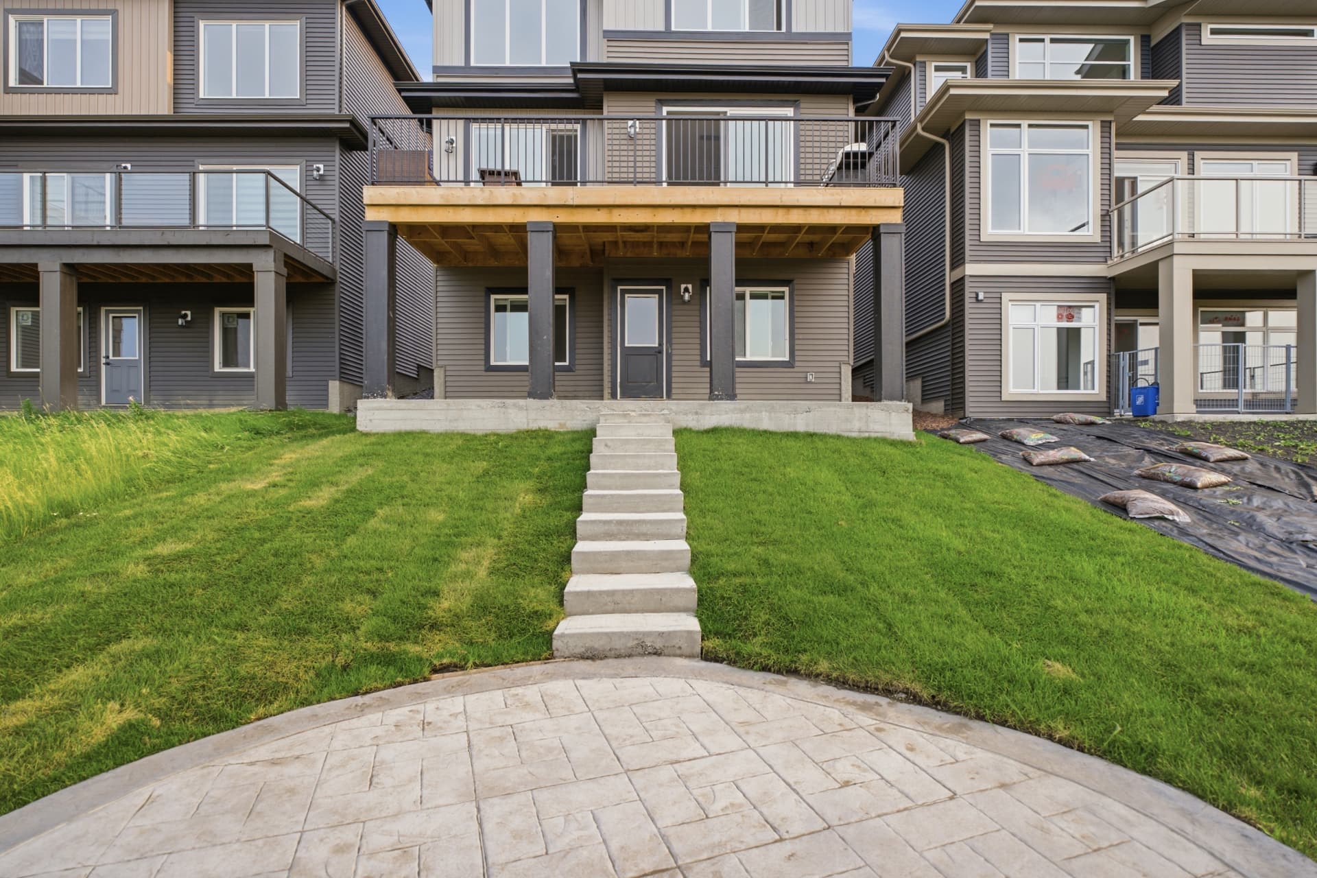 Rear elevation with deck, patio and landscaped yard
