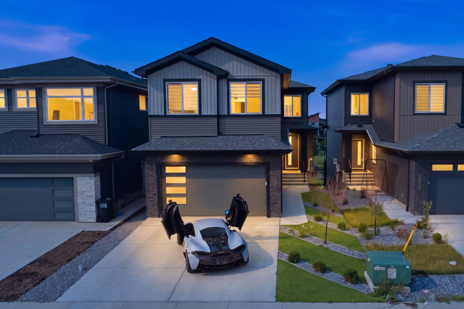 Front exterior of a modern home photographed at dusk