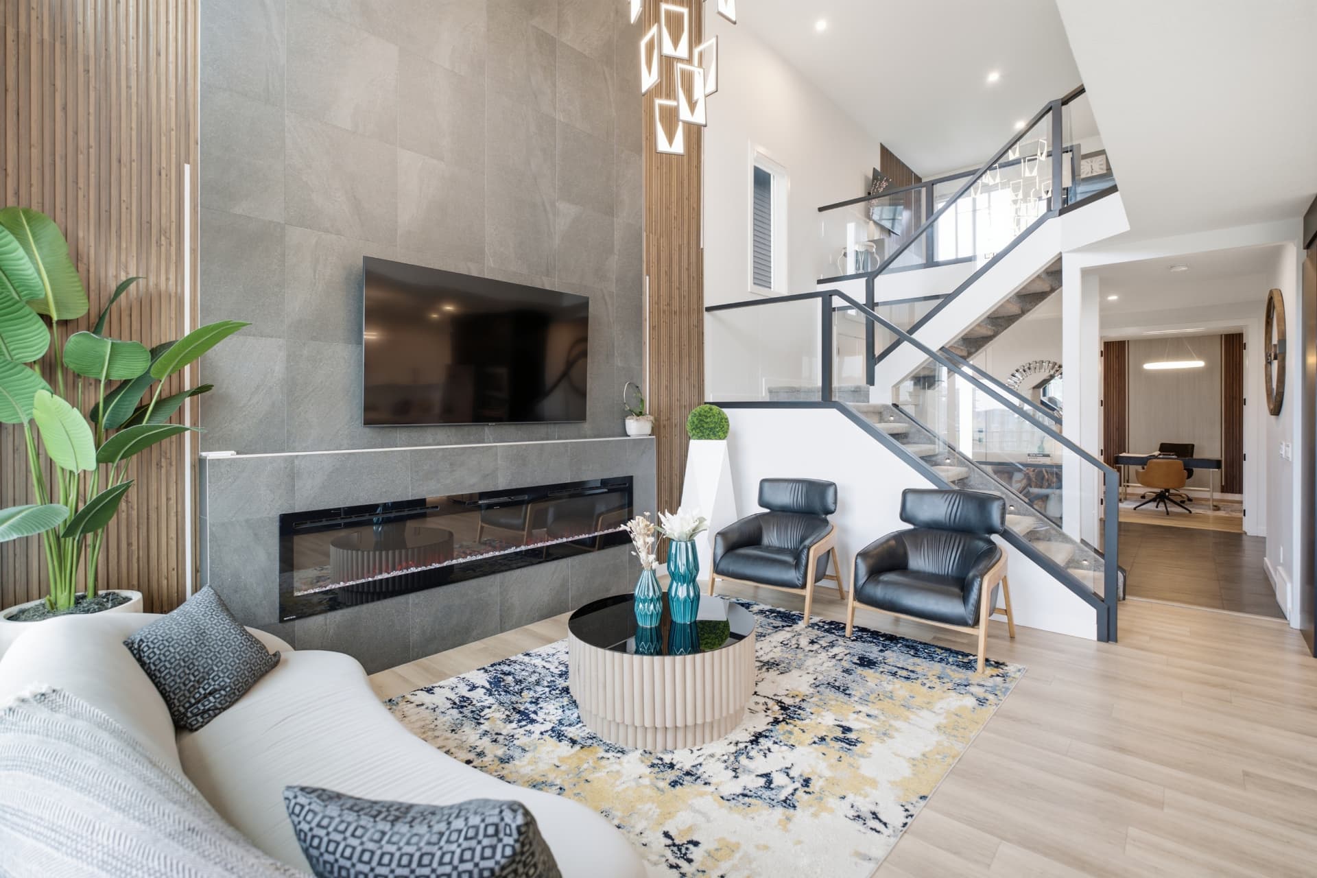 Living room with tile fireplace wall and staircase
